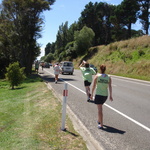 Tom chugs back some water on the run, with support from Gini