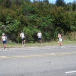 Anita handing off to Sarah, with two other B@stards looking on.