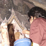 A worker working to restore parts of the Grand Palaces interior. There were dozens of workers working on various parts of massive internal paintings.