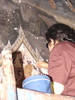 A worker working to restore parts of the Grand Palaces interior.  There were dozens of workers working on various parts of massive internal paintings.