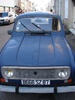 Cute old car in a street of newbees