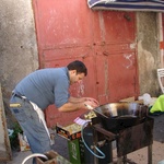 A street food vendor selling deep fried potato balls