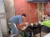 A street food vendor selling deep fried potato balls