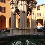 An old well in the center of one of the Piazzas