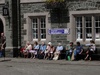 Tavistock oldies enjoying the sun as a wedding entourage forms