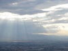The sun, streaming through the clouds.