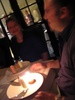 Nigels comes out with a candle.