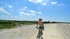 Pirate Gini biking along the coastline toward La Rochelle's center