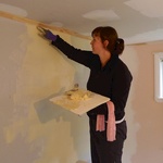 Gini lends a hand with the final coat of plaster