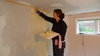 Gini lends a hand with the final coat of plaster