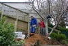 With the help of foreman Robin the posts get concreted in.