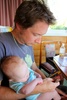 Playing a fun new board game - 7 Wonders. Olive helps Dad.