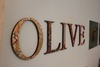 Olive watches as she gets her name on the wall!