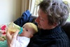 Olive gets afternoon tea from a bottle fed by Dad and slurps down every drop.