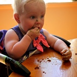 Olive's first taste of cake with icing. 