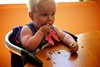 Olive's first taste of cake with icing. 