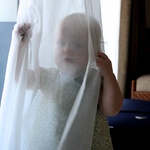 Playing peekaboo in the curtain