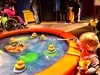Fishing for ducks, looking in mirrors, playing cafe, digging for balls at science museum in Melbourne.