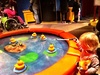 Fishing for ducks, looking in mirrors, playing cafe, digging for balls at science museum in Melbourne.