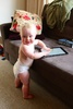 Elevan months and crawling and pulling herself up on the couch and coffee table.