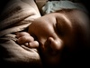 Escaping the swaddle. A borrowed merino swaddle is working a treat!