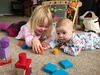 This morning Iris desperately wanted to join us building block towers. So she rolled over to join in.