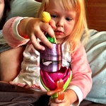 Playing with her purple slinky and tinkerbell
