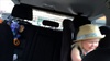Olive found Tom's hat and my sunglasses beside her while we were driving. She puts them both on and states 