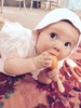 Iris Ann in her great Aunty Pat & Uncle Peter outfit which is gorgeous, doing what she does best - putting something in her mouth!