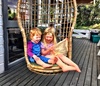 Two cuties in the swing chair.
