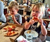 Sharing a pizza with Ants. The first time we've seen Olive eating pizza properly! Had half a pizza between them!