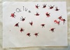 Jumping frogs, flowers and hearts. Signed by Olive.