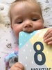 Eight months old. Our cheeky berry. Sitting quite well now, still loves her food. We seem to be doing circle movements on the floor and lifting her bottom up a bit so crawling soon?