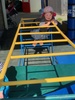 Loves hanging off the monkey bars... got into the planting and watering...