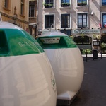 Huge recycling bins in the middle of an old street