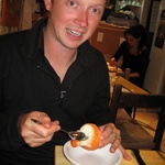Enjoying an orange filled with orange sorbet!