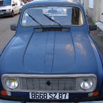 Cute old car in a street of newbees