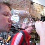 Tasting the wine from the biggest glass ever.