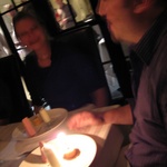 Nigels comes out with a candle.
