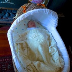 Asleep for the first time in her bassinet.