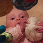 By holding the wool